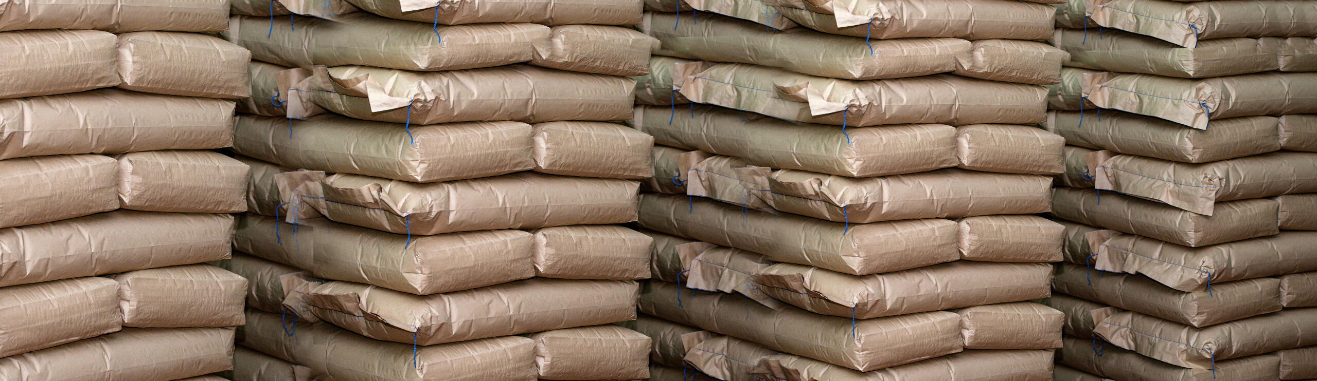 Brown bags of hemp seeds stacked in a warehouse